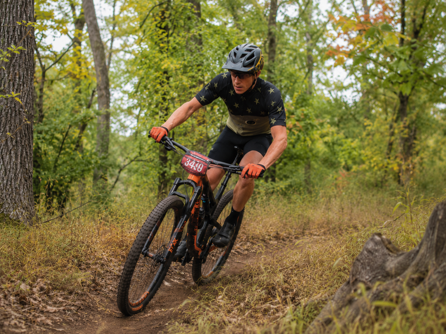 Logan Steele mountain biking on a wooded trail